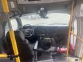 Interior view of a 2017 Chevrolet Express featuring a driver's seat dashboard controls and a rearview mirror