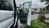 A 2017 Ford Transit van with the driver's side door open