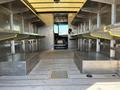 Interior view of a 2011 Ford Econoline with metal shelving on both sides and a wooden floor showing two raised platforms