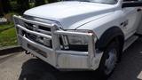 A white 2014 RAM 5500 with a silver bull bar and chrome accents on the front grille