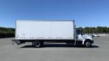 A 2019 International 4300 box truck with a white cargo area and black chassis parked on a paved surface