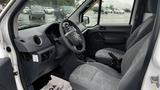 Interior of a 2012 Ford Transit showing two gray seats and a dashboard with gauges and controls