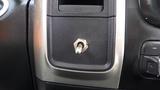 A close-up of a metallic toggle switch embedded in a black and silver panel in a 2014 RAM 5500