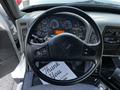 The interior of a 2011 International 7300 with a black steering wheel displaying gauges and controls along with a dashboard featuring various indicators and a thank you mat