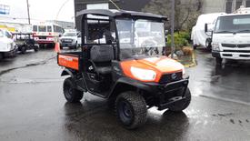 A 2020 Kubota RTV 900 utility vehicle with an orange and black exterior features a cab with glass windows and a cargo bed at the rear