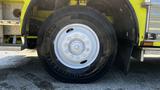 Close-up of a white wheel and tire of a 1995 Freightliner FLL086 with a visible Continental branding on the tire sidewall