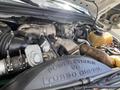 Engine compartment of a 2010 Ford F-550 showcasing the Powerstroke V8 Turbo Diesel engine with various components and hoses visible