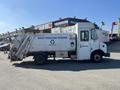 A 2010 Freightliner MT45 garbage truck with a white exterior and signage indicating a waste reduction program and recycling