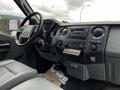 Interior view of a 2011 Ford F-250 SD showcasing the dashboard with controls stereo system and gear shift in a gray color scheme