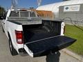 A 2017 Ford F-150 pickup truck with an open truck bed and a metal storage rack in the back