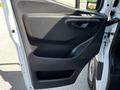 The interior door panel of a 2022 Mercedes-Benz Sprinter featuring a sleek design with a handle and storage compartment