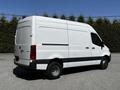 A 2022 Mercedes-Benz Sprinter van with a white exterior and black accents is parked with its rear facing the viewer showcasing its cargo design
