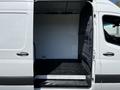 A 2022 Mercedes-Benz Sprinter with the side door open revealing a spacious empty interior designed for cargo or equipment storage