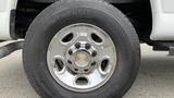 Close-up of a chrome wheel on a 2017 Chevrolet Express Quigley 4x4 featuring a Chevrolet logo in the center and a Continental tire with visible tread detail