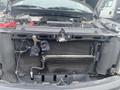 The image shows the engine compartment of a 2013 Ford F-150 with a visible radiator and various engine components including hoses and fans