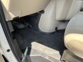 Interior view of the footwell area of a 2012 Ford Econoline showing the floor mat and pedals without the seats or dashboard visible