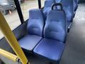 Two blue fabric seats in a 2017 Chevrolet Express van with a simple design and minimal padding