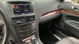 Interior view of a 2013 Lincoln MKT highlighting the dashboard with a touchscreen display and wood accents