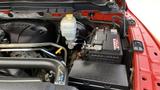 Under the hood of a 2013 RAM 2500 showcasing the engine components battery and fluid reservoir