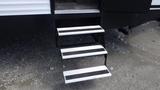 A set of three black and white steps leading up to a forest river travel trailer model 2021 Forest River 312BH East To West Della Terra