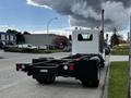 2014 Kenworth T370 truck viewed from the rear with a flatbed design and tall exhaust pipe