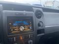 Dashboard of a 2013 Ford F-150 featuring a Pioneer stereo system displaying the time and radio frequency