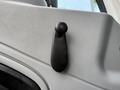 A black door handle on the interior of a 2007 International 4200 vehicle