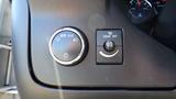 Close-up of the control panel of a 2012 GMC Savana featuring light control knob and fog light switch