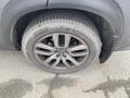 Close-up of a gray wheel and tire of a 2021 Lexus NX 300 featuring a multi-spoke alloy rim with a Continental TrueContact tire