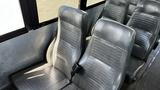 Interior view of gray vinyl seats in a 2014 Freightliner Thomas Bus Diesel with a minimalist design and safety seatbelts