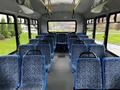 Interior of a 2017 Chevrolet Express with multiple blue and gray patterned seats arranged in rows