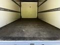 Empty interior of a 2020 Hino 195 truck with a flat floor and walls lined with metal strips