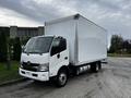 A 2018 Hino 195 truck with a white box body parked at an angle showcasing its front and side view