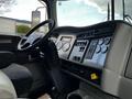 Interior view of a 2014 Kenworth T370 featuring a steering wheel dashboard controls and various gauges