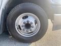 A close-up of a 2017 Chevrolet Express tire and rim showing the metal wheel with multiple bolts and a tire with visible tread pattern