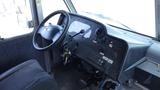 Interior view of a 2011 Ford Econoline showing the driver's seat steering wheel dashboard and control panels