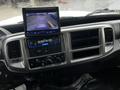 Dashboard of a 2020 Hino 338 featuring a central display screen for rear-view camera and various control buttons and knobs for climate and audio settings