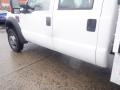 A 2009 Ford F-450 SD truck in white with a distinct side view featuring a door and wheel visible from the foreground