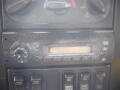 Control panel of a 2008 International 7400 featuring knobs and buttons for various functions including a radio display