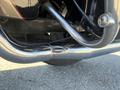 Close-up of the chrome exhaust pipe on a 2004 Harley-Davidson FLHTCUI showcasing its shiny surface and intricate curves