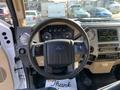 Interior view of a 2013 Ford F-450 SD focusing on the steering wheel dashboard controls and infotainment screen