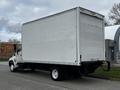 A white 2006 Hino 268 box truck with a plain rear and large cargo area parked on the street