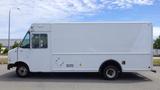 A white 2011 Ford Econoline box truck with a large cargo area and a driver's side door parked on a lot