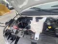 Engine compartment of a 2017 Chevrolet Express showing the engine components and coolant reservoir