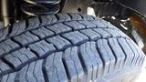 A close-up view of a tire from a 2015 Ford Econoline showing detailed tread patterns and grooves