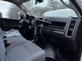 Interior of a 2018 RAM 3500 showing the driver's side with a gray seat and a mounted tablet holder on the dashboard