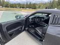 2017 Dodge Challenger with an open door showcasing the black leather interior and dashboard design