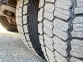 Close-up of a 2010 Freightliner MT45 garbage truck tire showing deep tread patterns and rugged texture