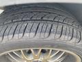 Close-up of a tire from a 1966 Ford Mustang showing detailed tread pattern and alloy rim