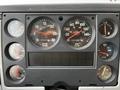 Dashboard of a 1994 Freightliner FL80 featuring various gauges for RPM speed fuel and temperature levels